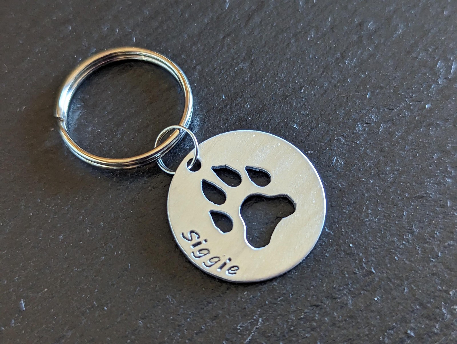 Sterling silver dog tag with paw print cut out – handmade and customized