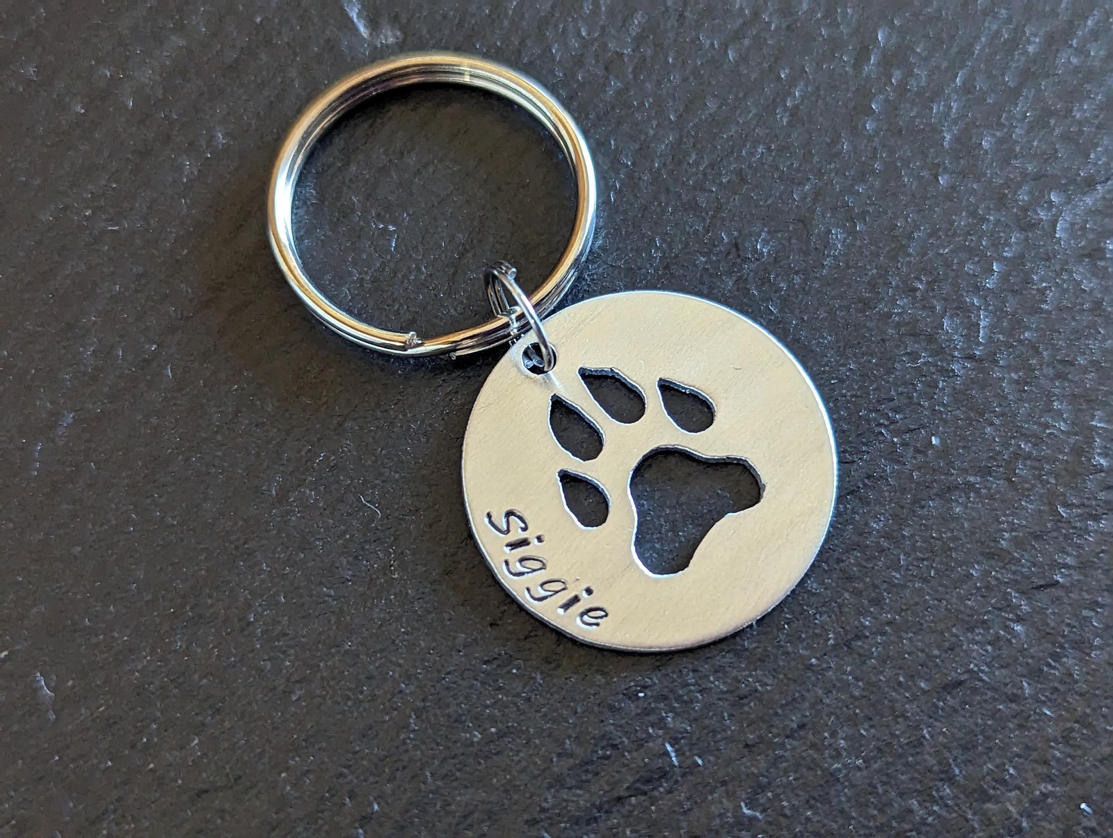 Sterling silver dog tag with paw print cut out – handmade and customized