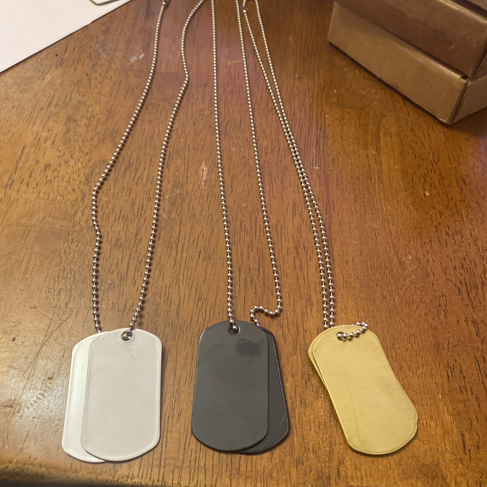 (3) Sets Of Military Dog Tags, (1) Silver, (1) Black, (1) Brass. Chains, Blank
